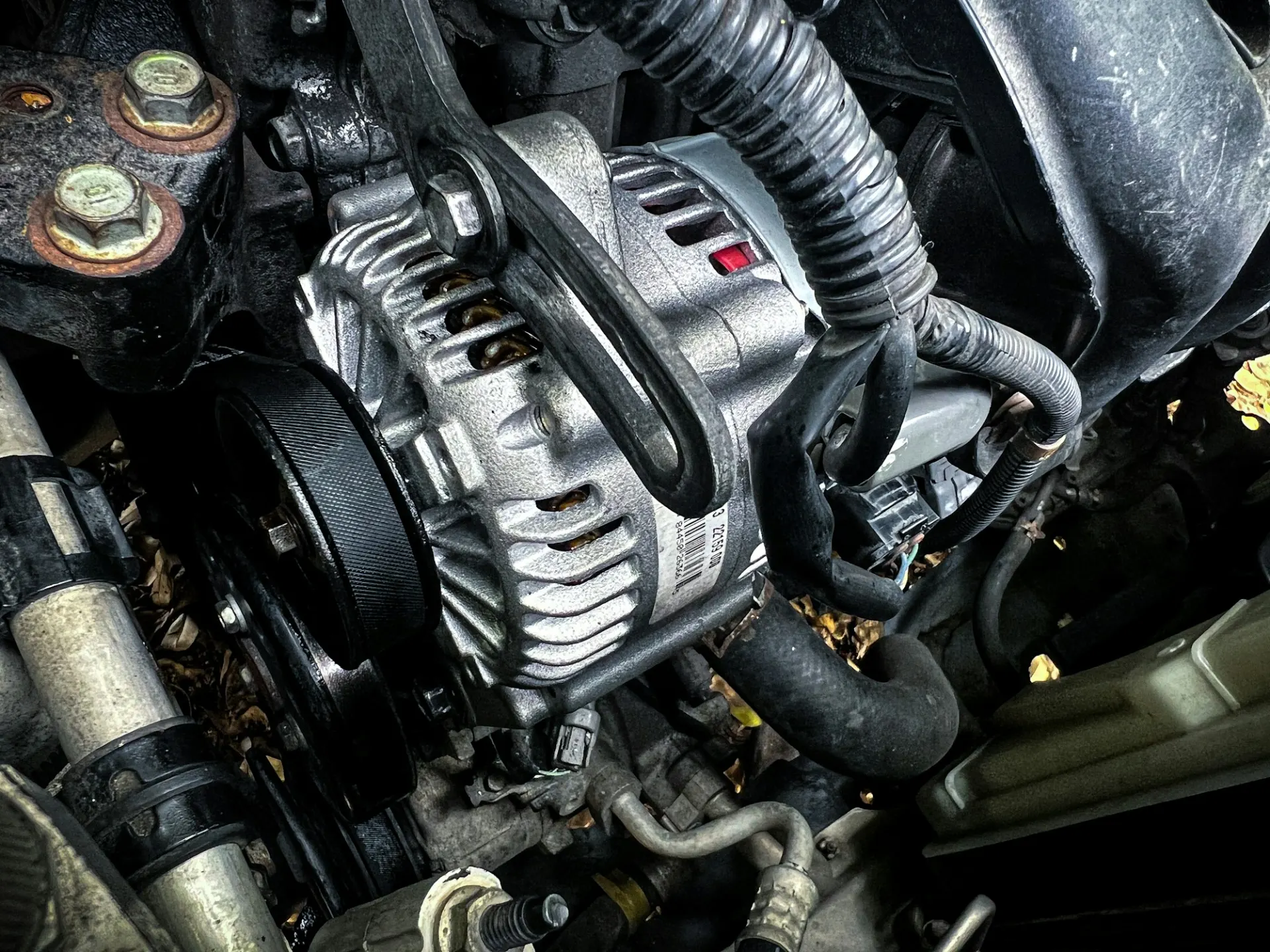Alternator in a car engine bay