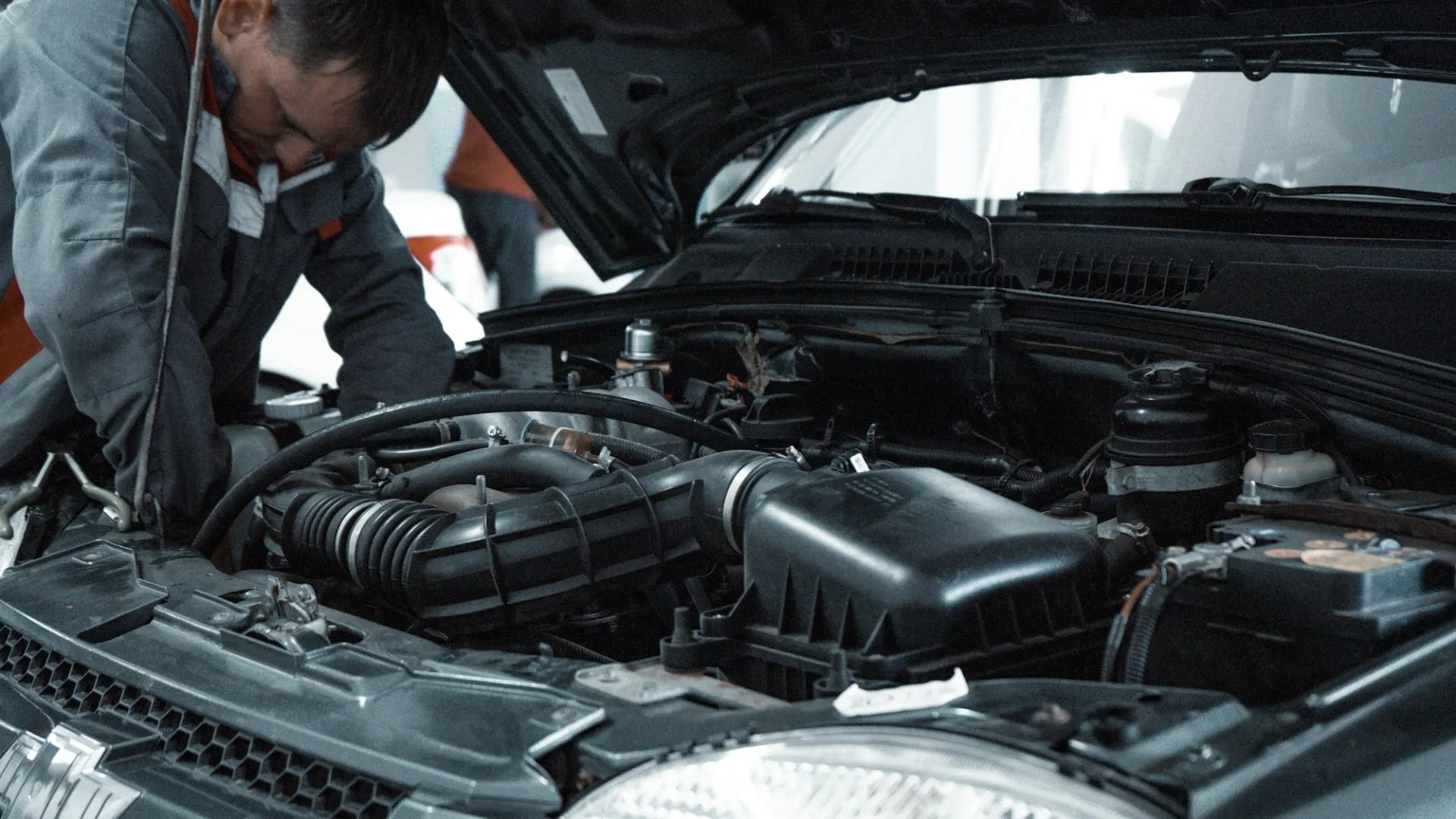Mechanic checking a car engine during a service