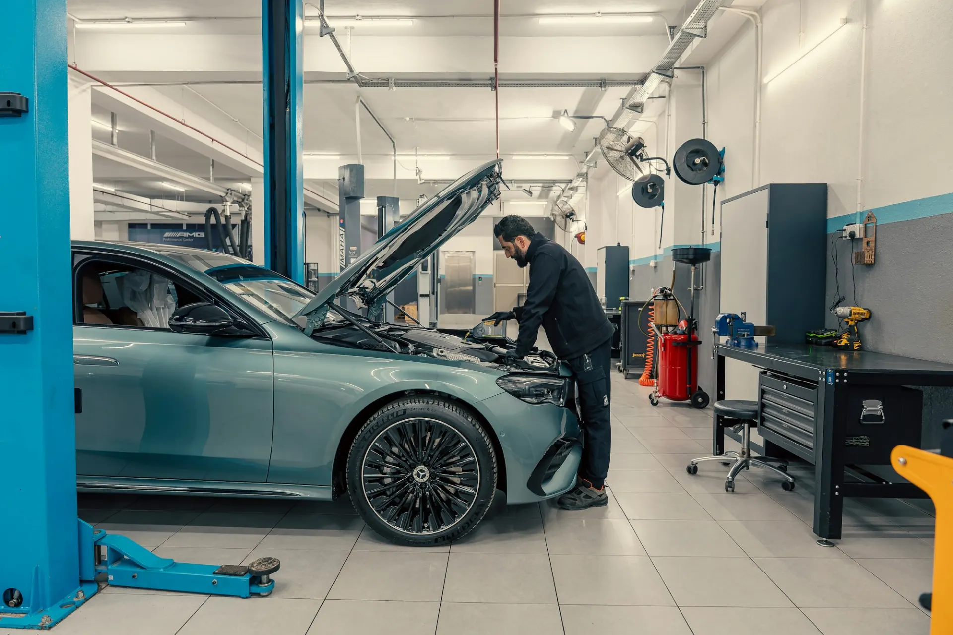 Mechanic working on a car engine in the workshop